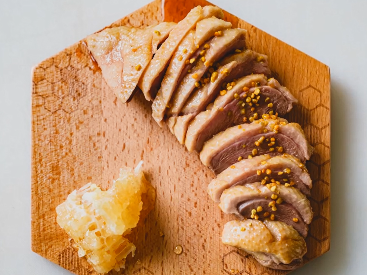 A plated dish of sliced duck and honeycomb