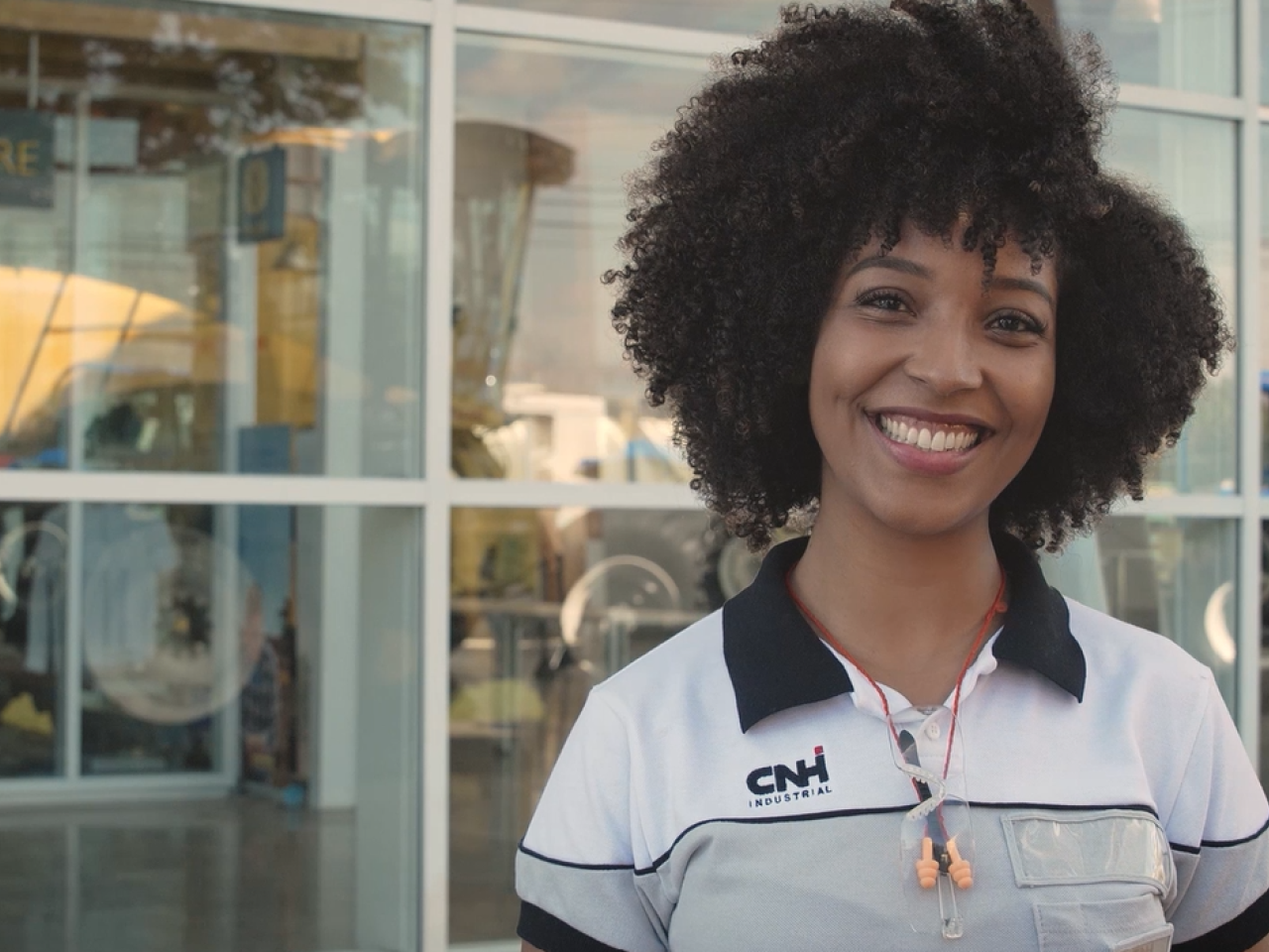 A person in CNH uniform outside a building