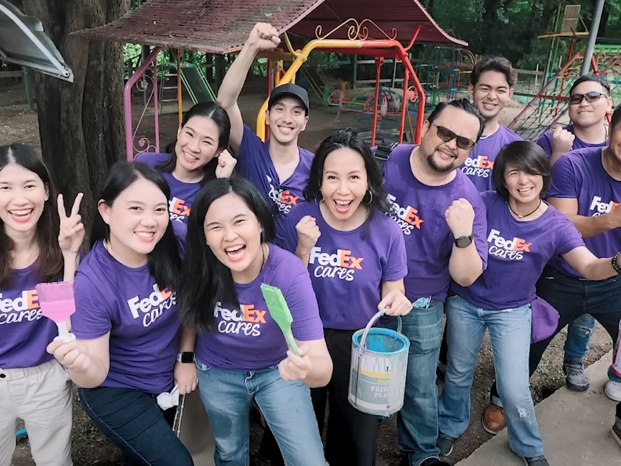 A team of volunteers, smiling to the camera.