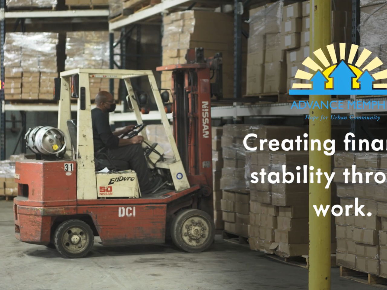 A person operating a forklift in a warehouse.