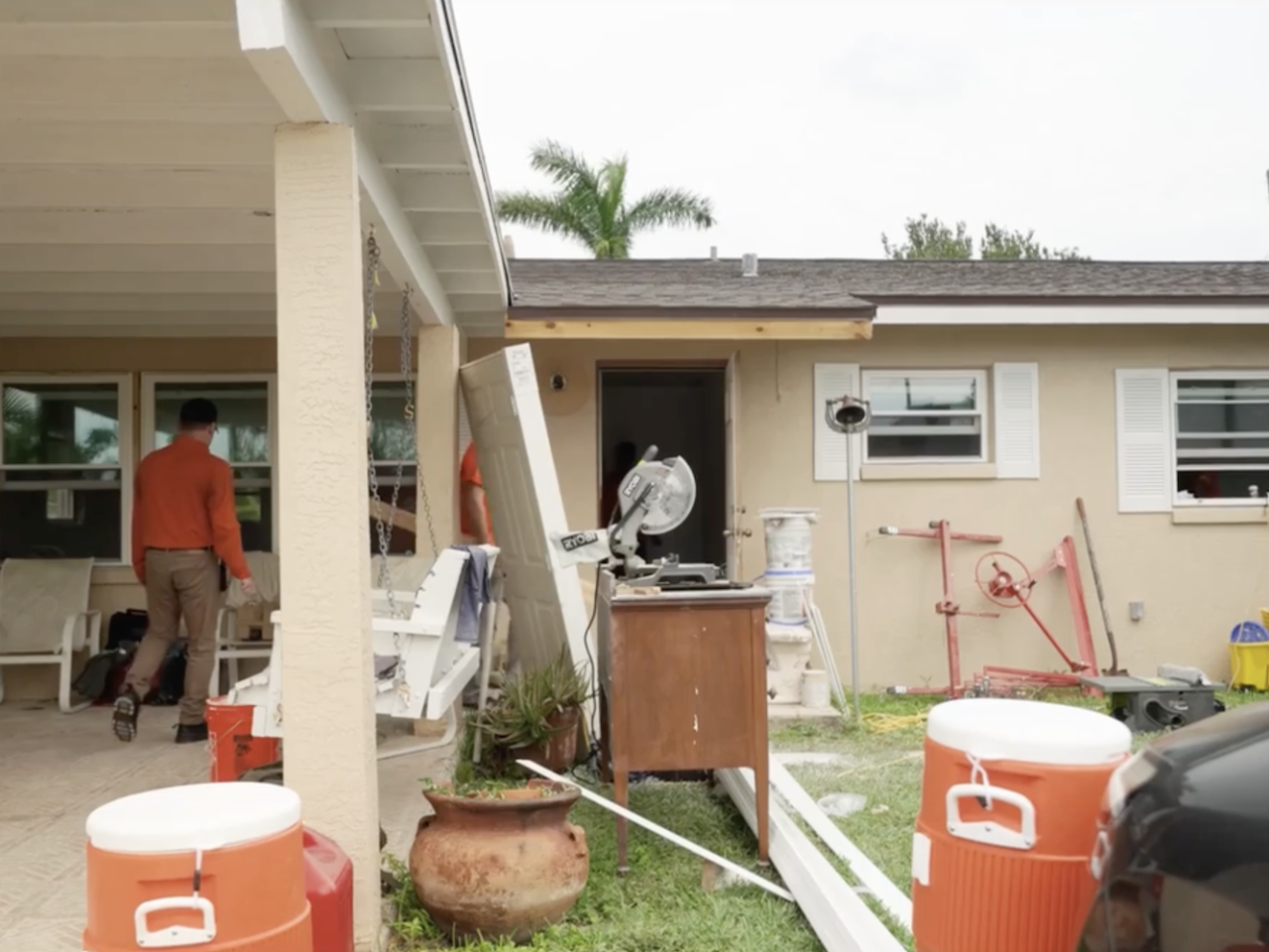 volunteers walking in to a house 