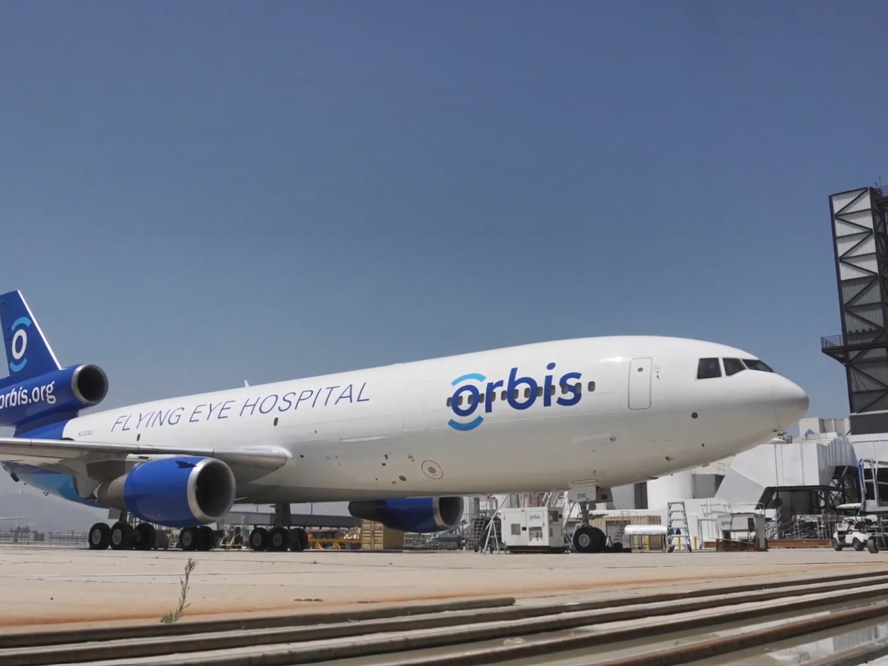 A large plane with Orbis logo on the side.