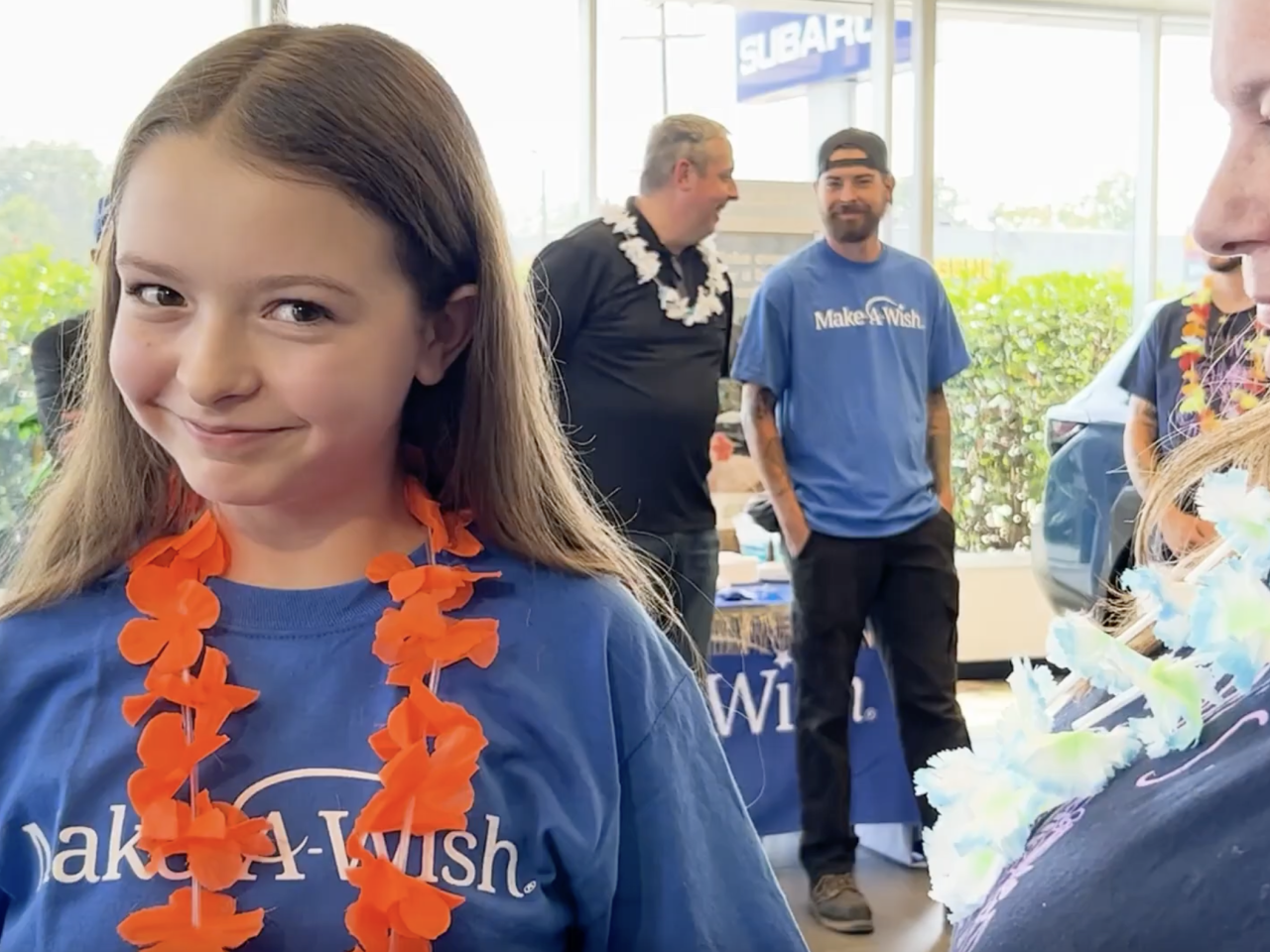 Smiling child wearing Make-A-Wish t-shirt