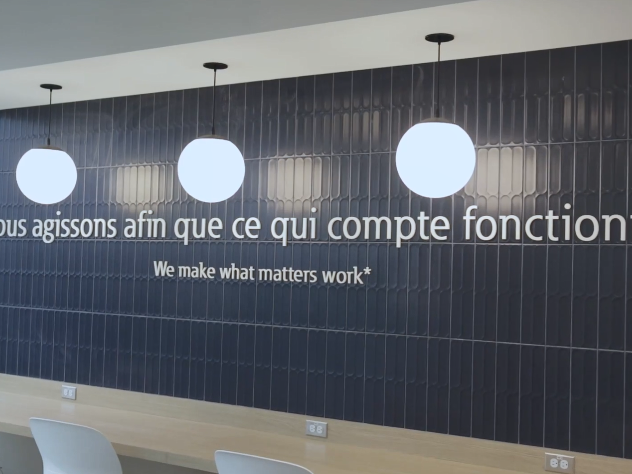Slogan on a wall in an office setting.