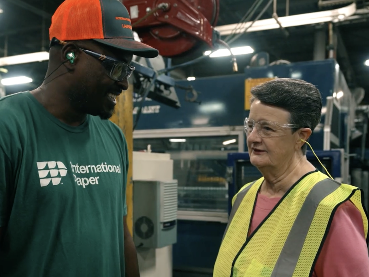 people talking in a factory