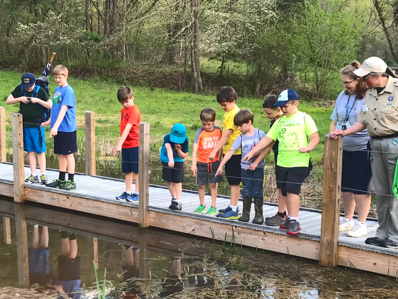 A group of children on a trail overlooking a body of water.