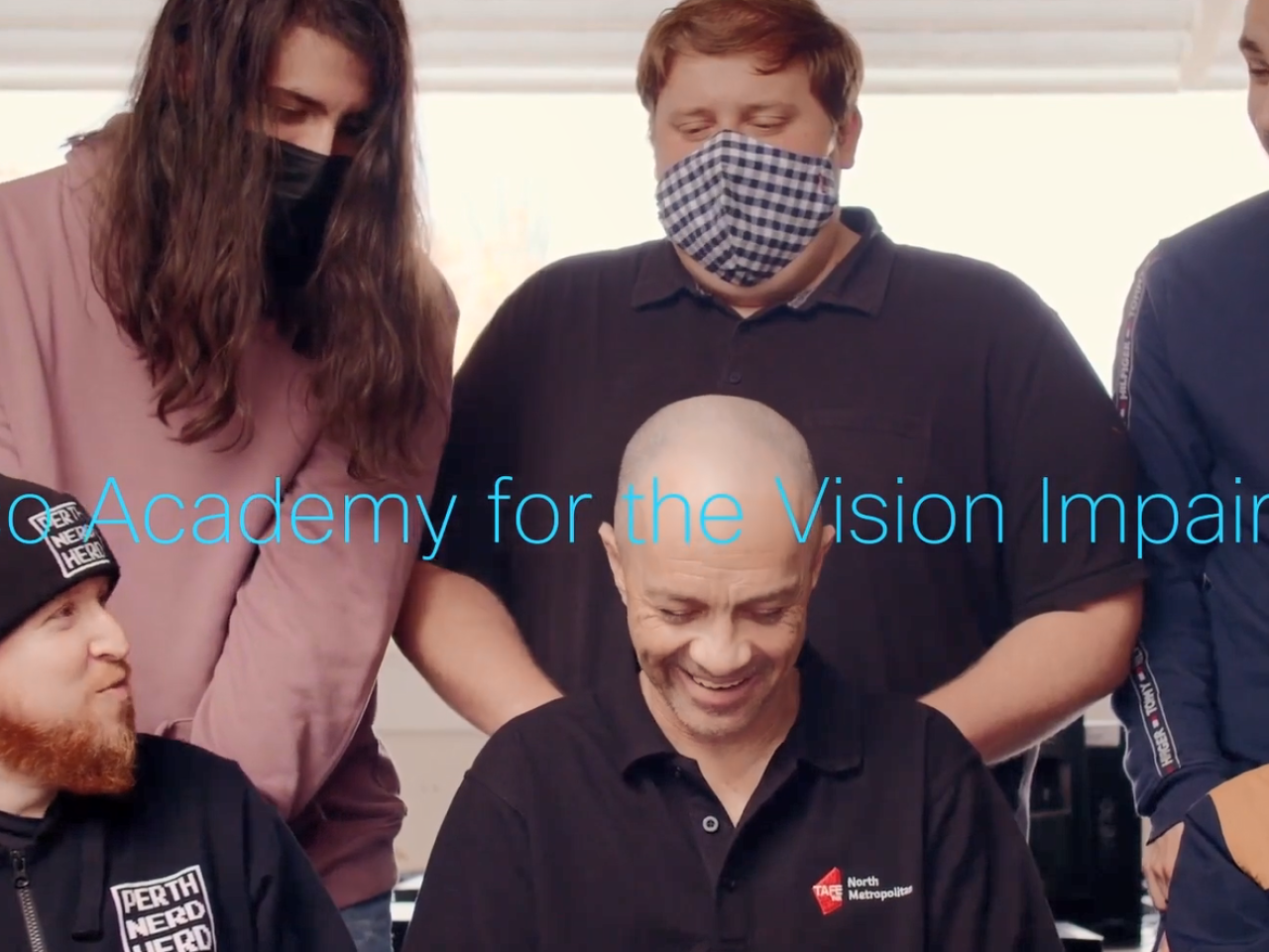 Neil and students seated around him. "Cisco Academy for the Vision Impaired".