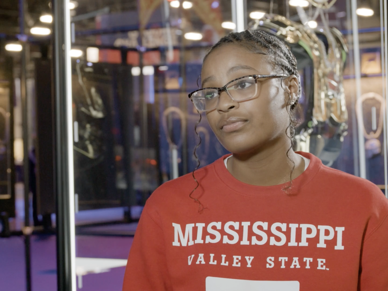 A person wearing a red university sweater 