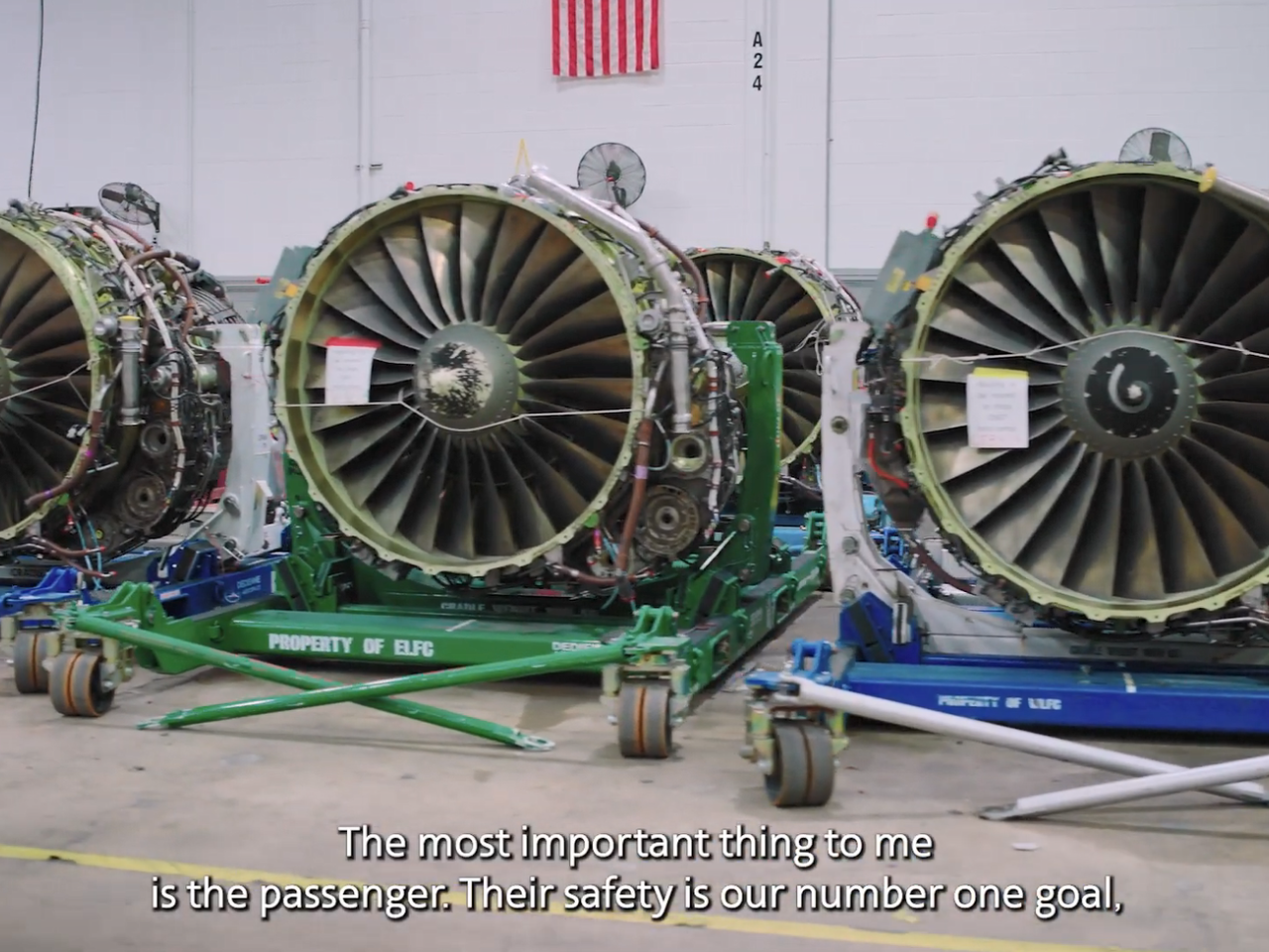 A row of airplane engines on trollies.