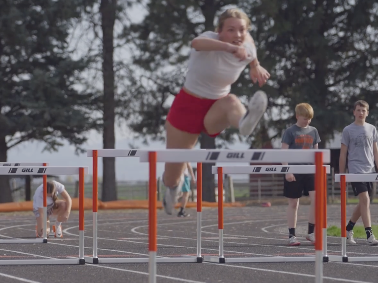 athlete jumping a hurdle