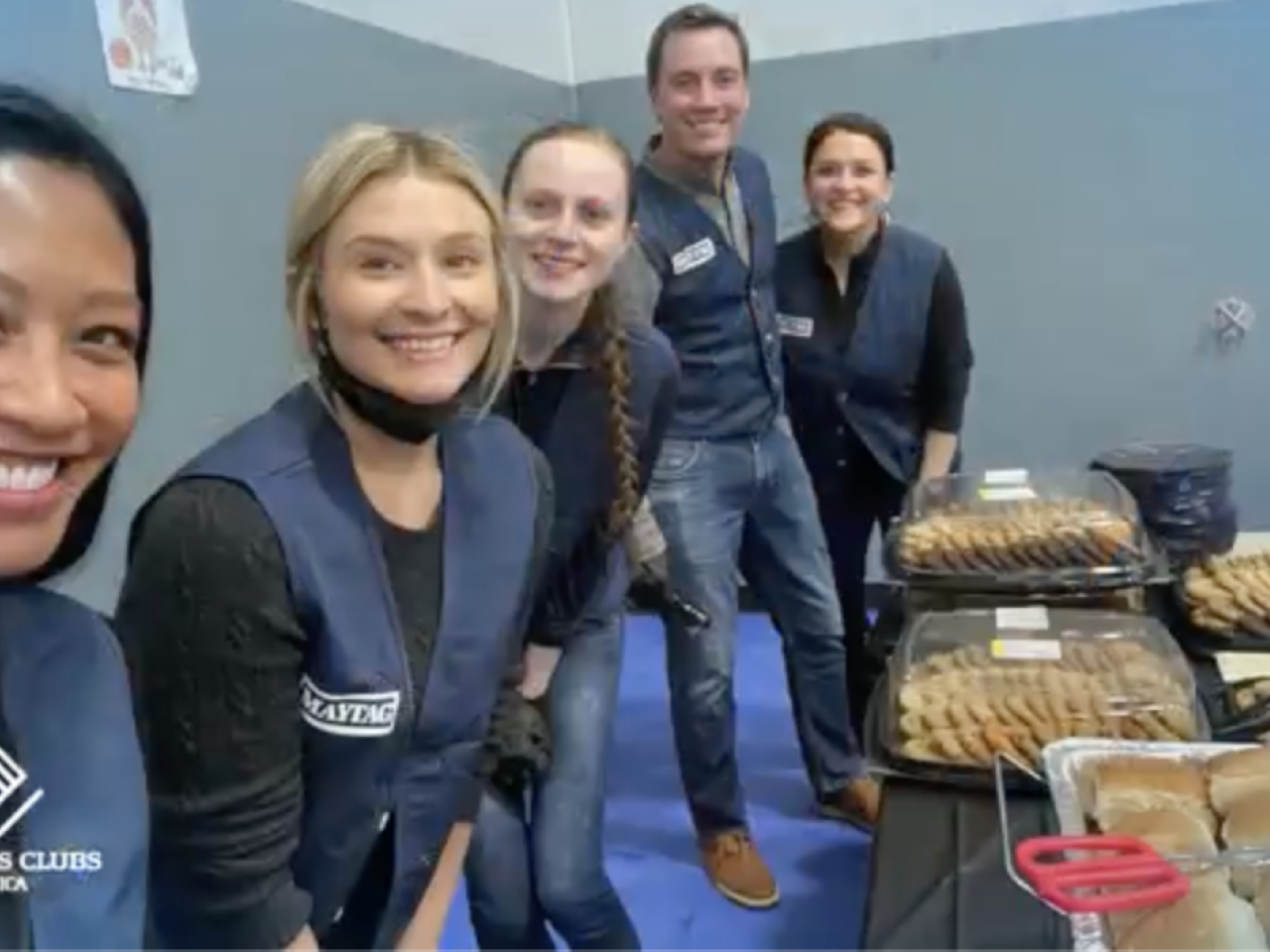 volunteers at tables of food