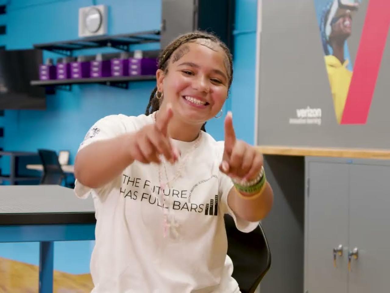 A person smiling and pointing to the camera