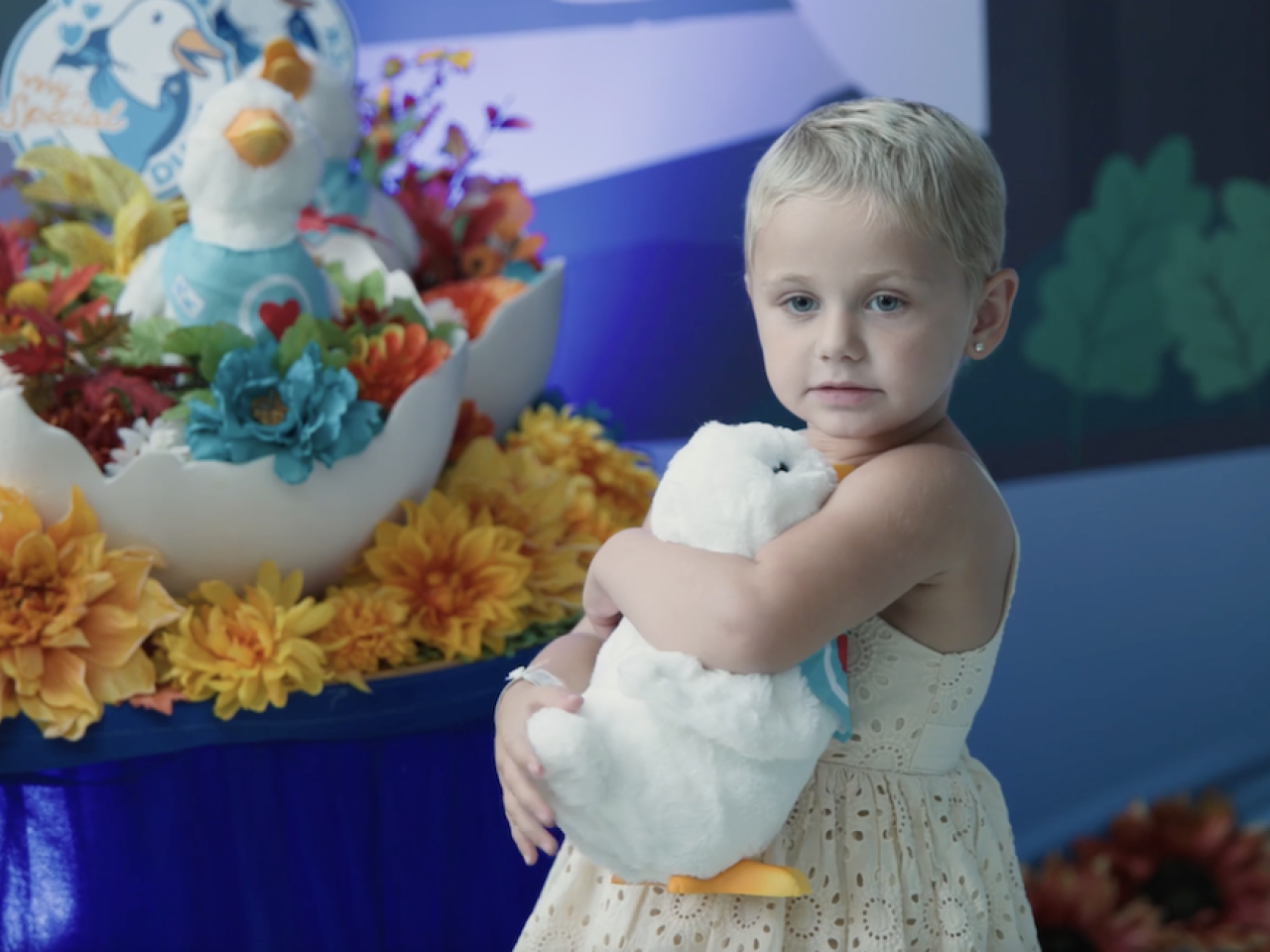 Young girl holding her Aflac My Special Duck