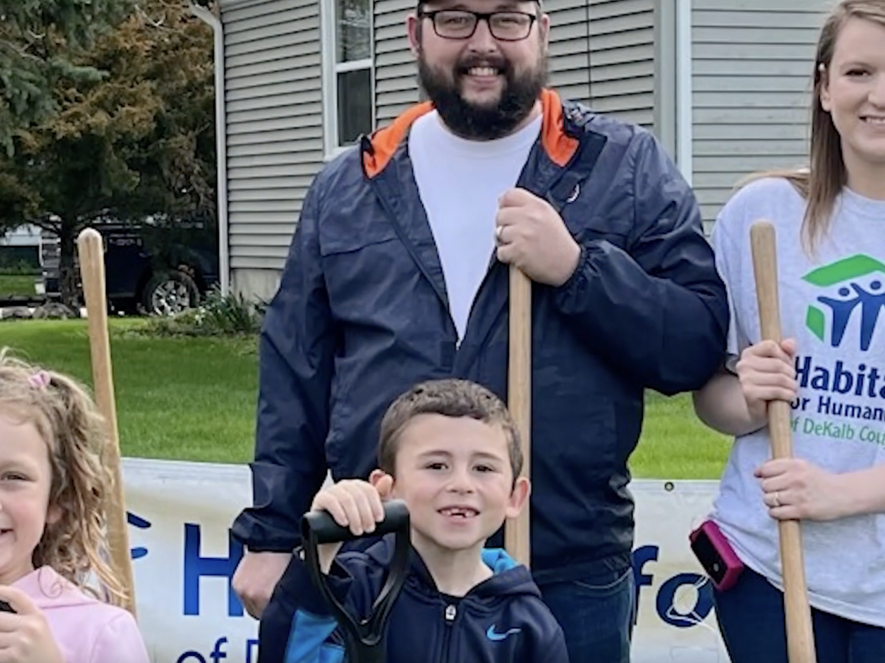 Family with two kids all holding shovels
