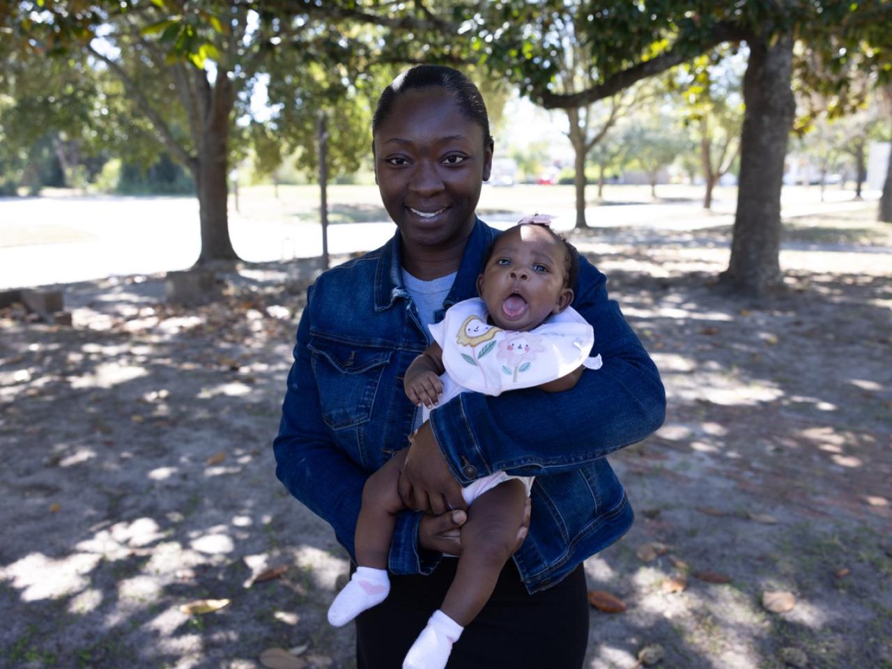 A young mother holding her baby