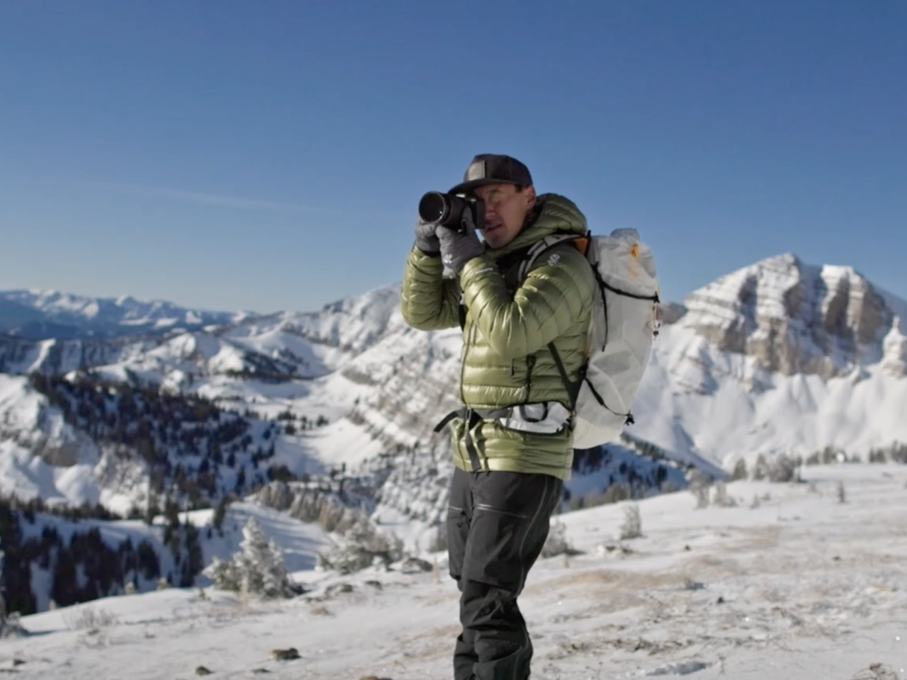 Jimmy Chin taking a photo on a mountaintop 