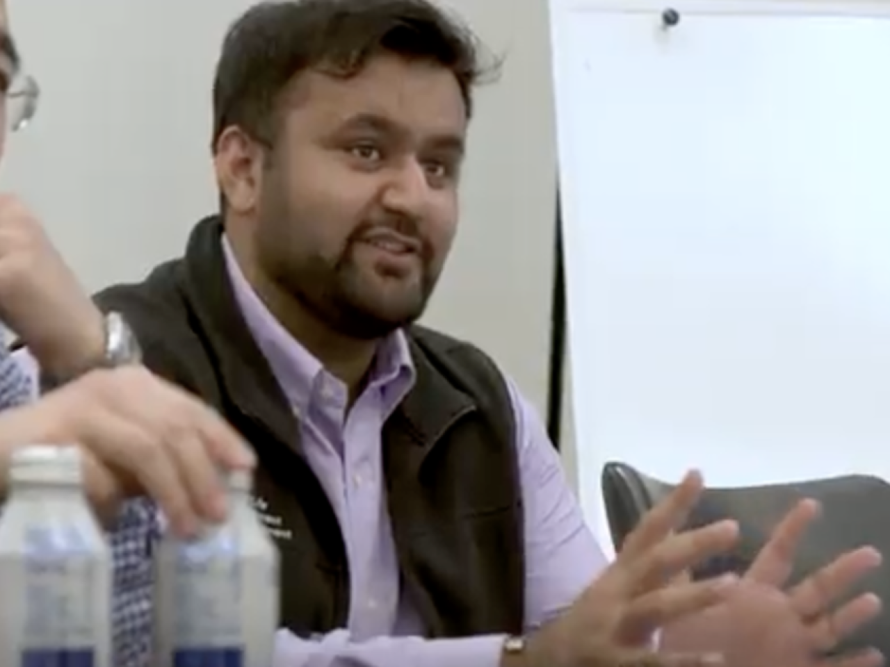 Person speaking at a conference table