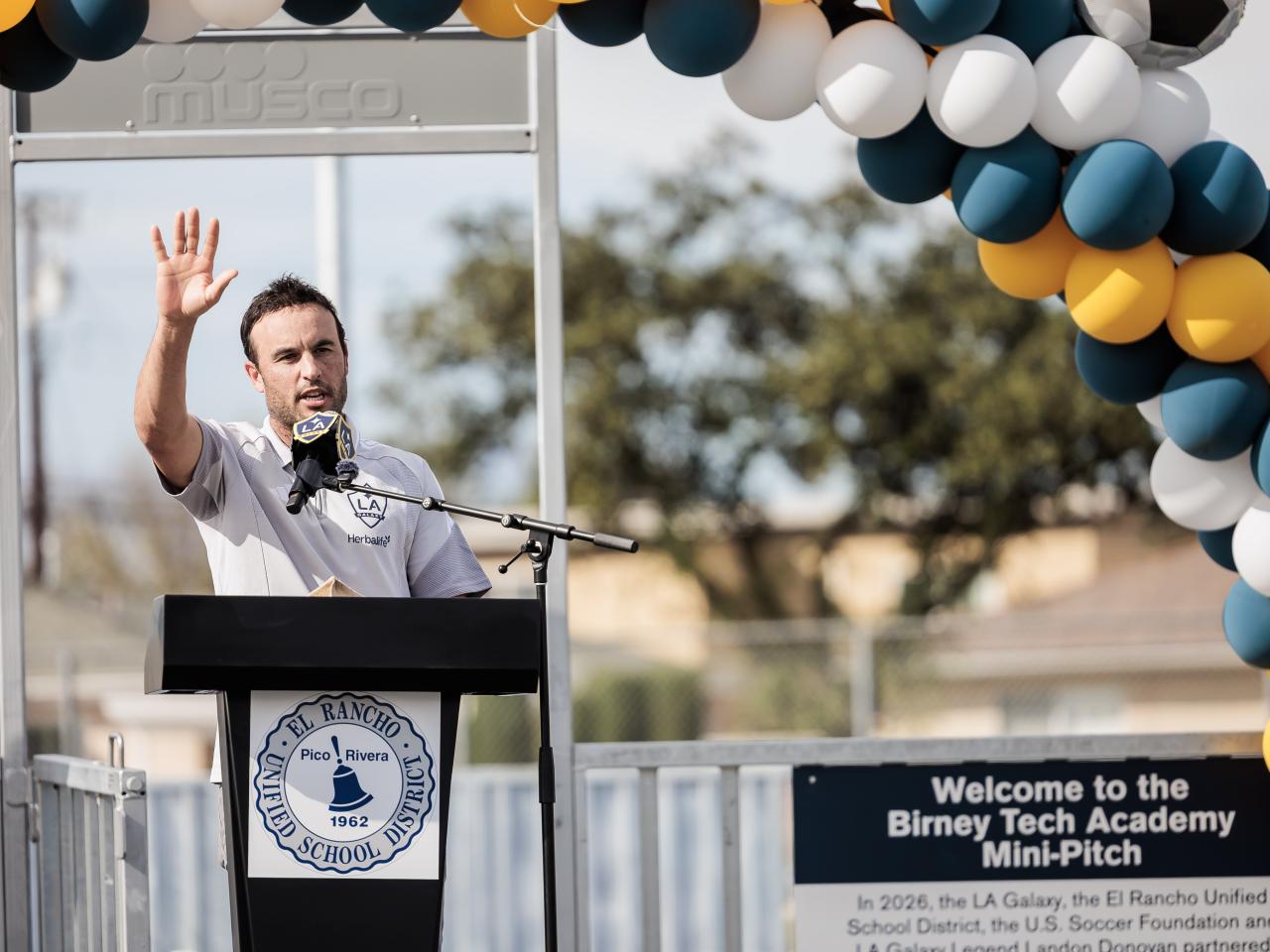 Landon Donovan speaking at podium