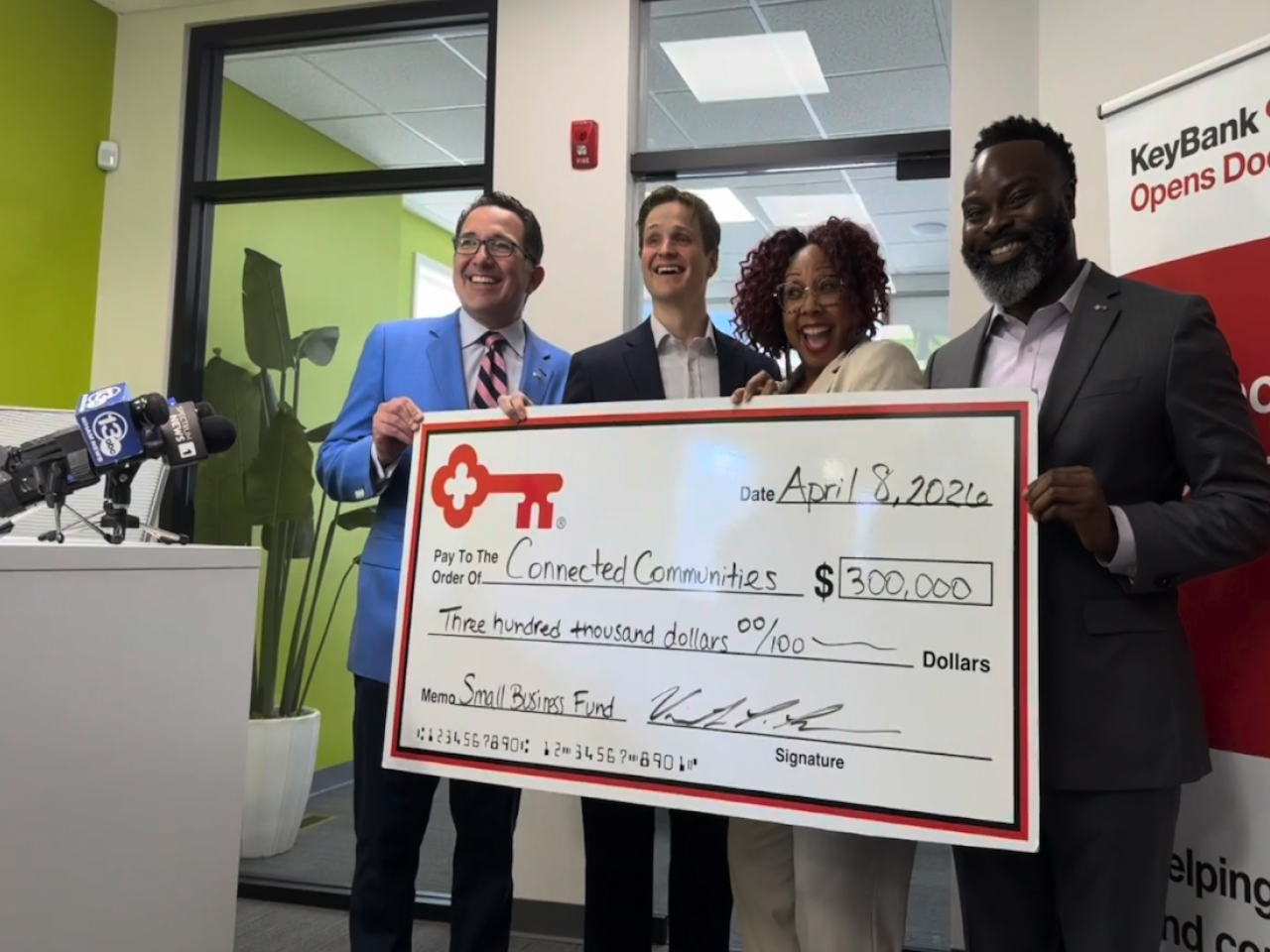 Team members from The KeyBank Foundation present a check for $300,000.