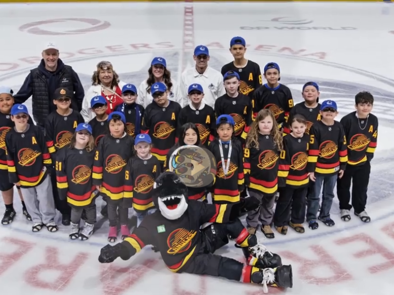 Kids posing on the ice with mascot