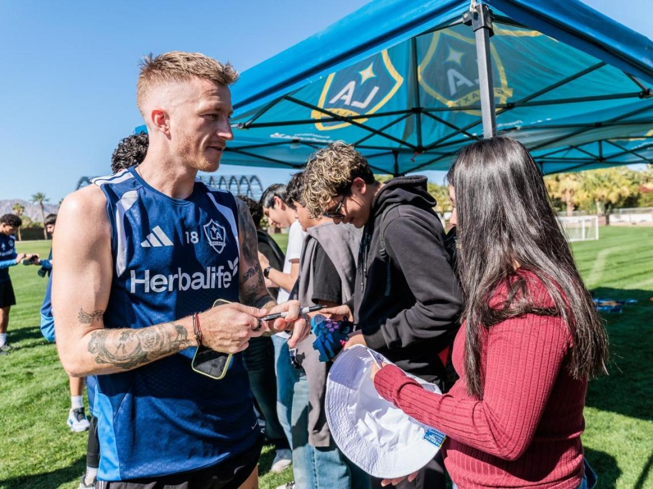 Students participate in an autograph session with LA Galaxy players following a behind‑the‑scenes look at professional training at the Empire Polo Grounds.