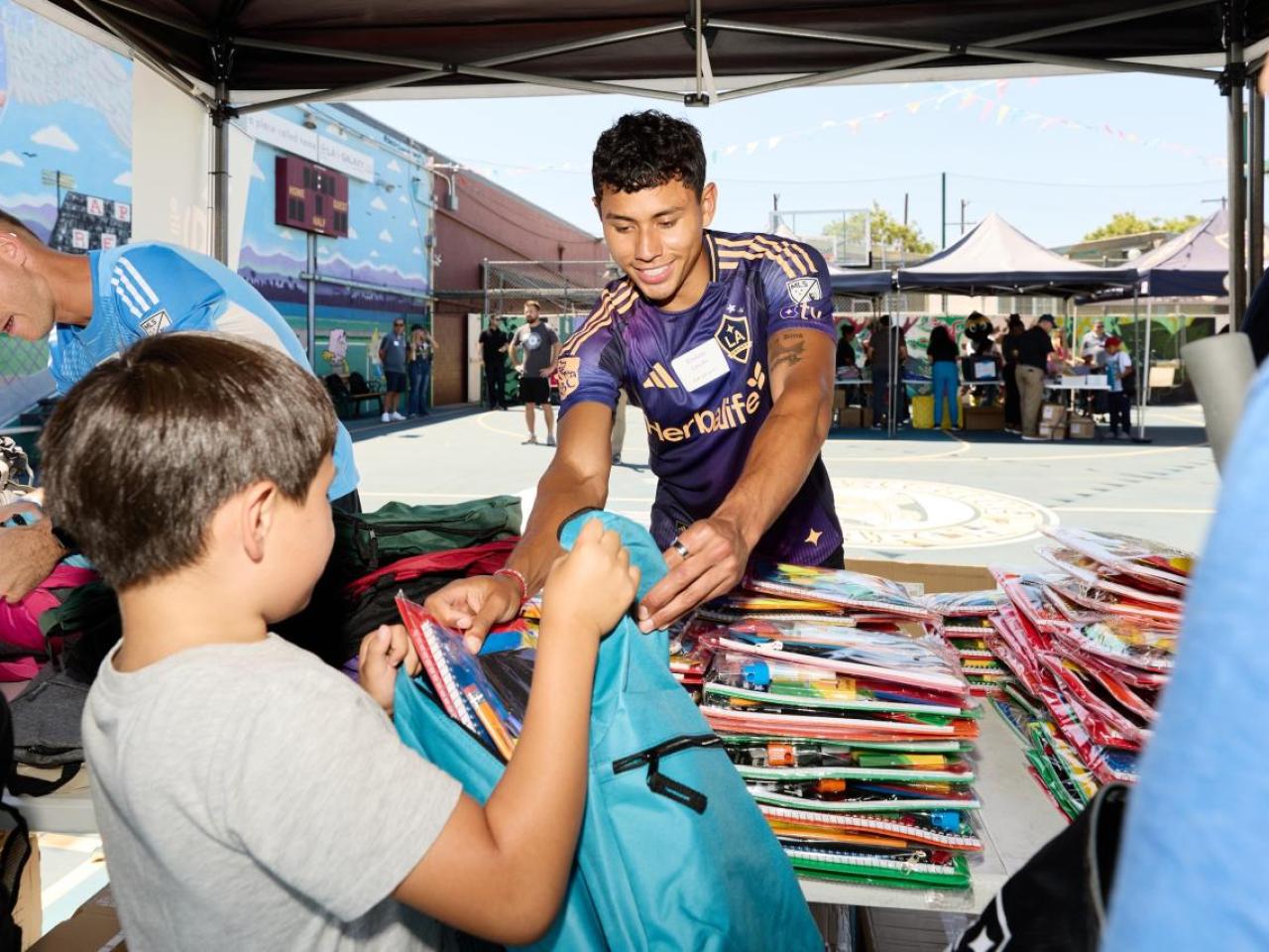 LA Galaxy midfielder Edwin Cerrillo helped hand out school supplies to students.