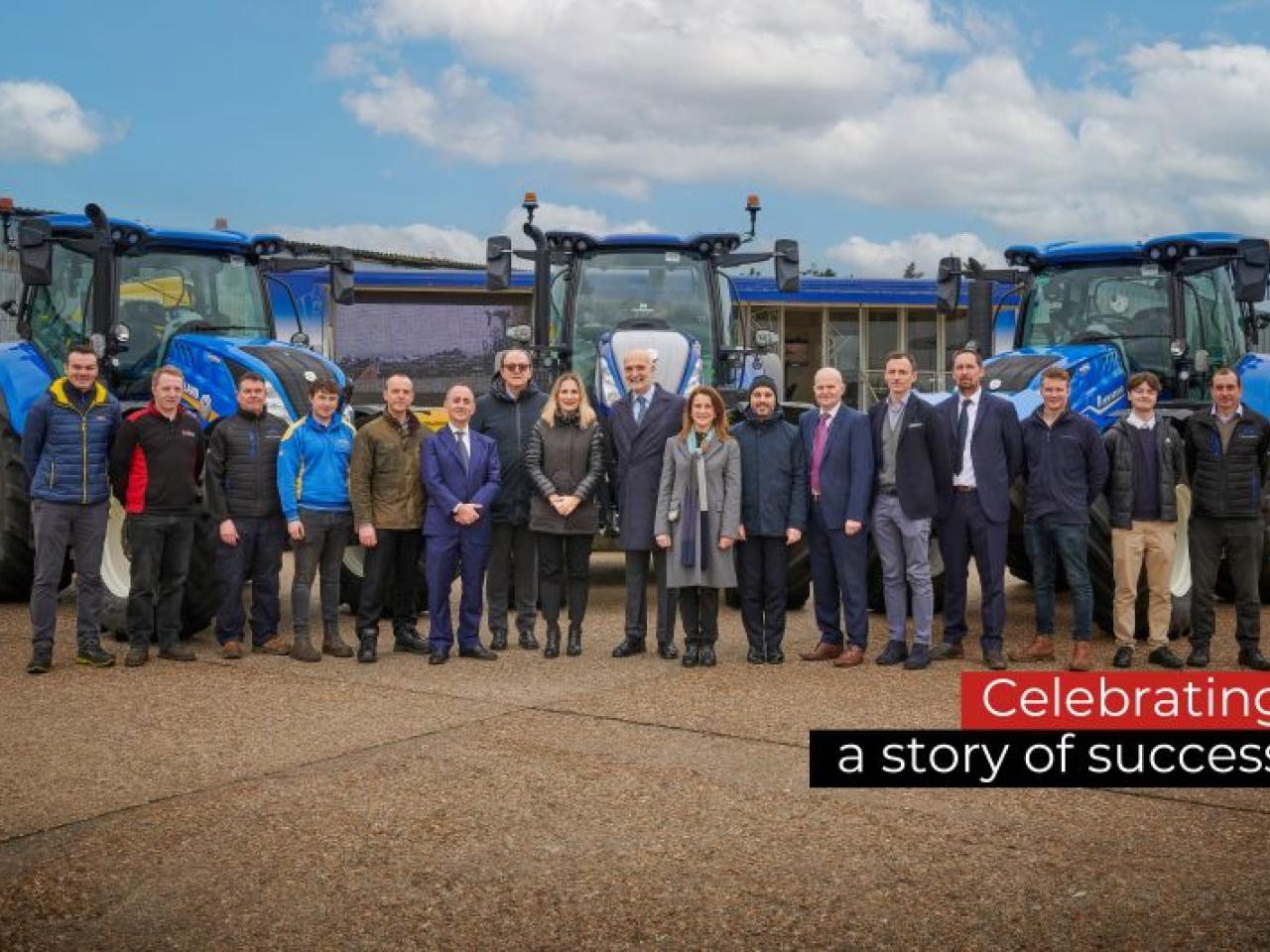 People standing together in front of blue machinery