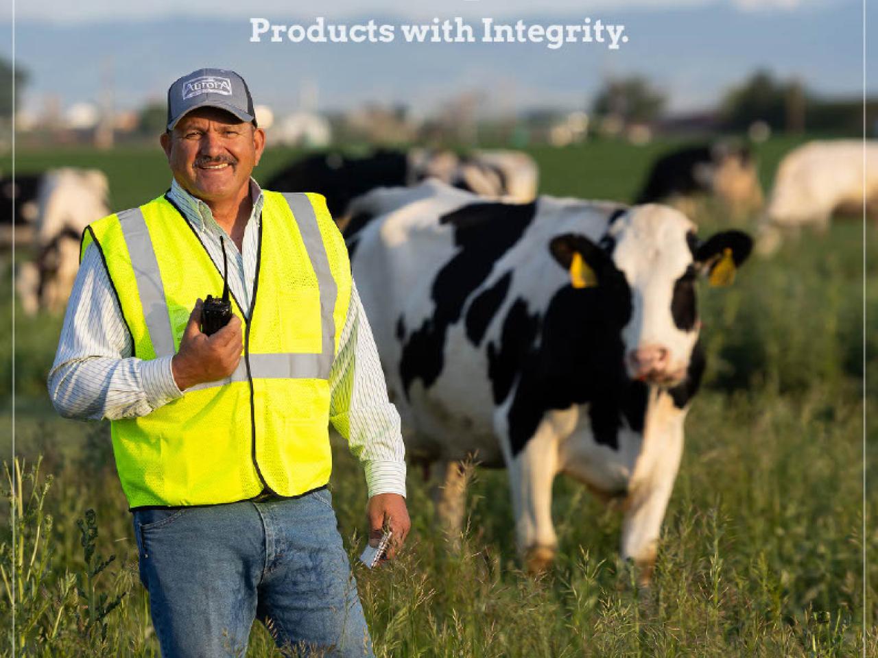 Sustainability Report cover with an employee and cows
