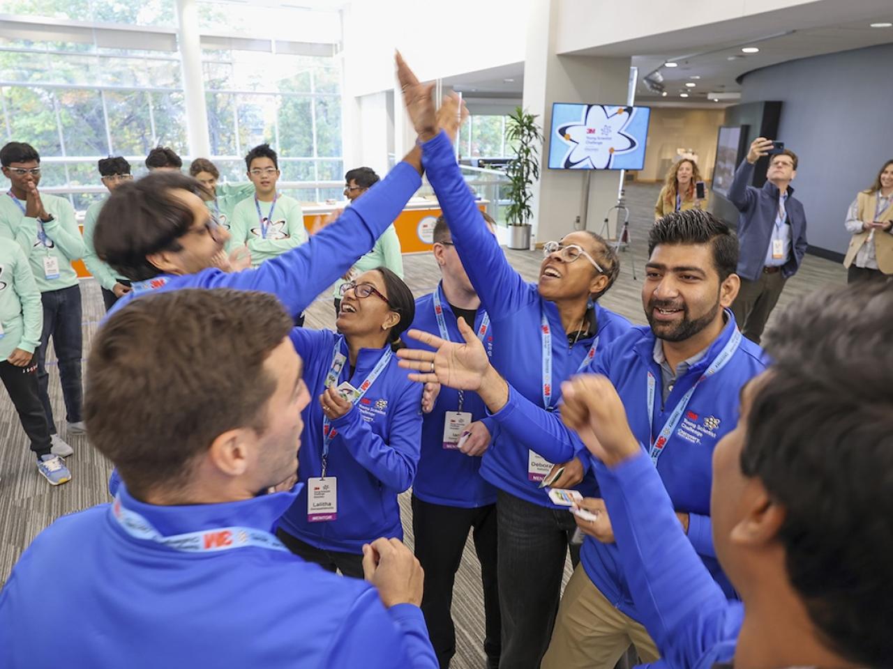 3M Young Scientists giving a high five.