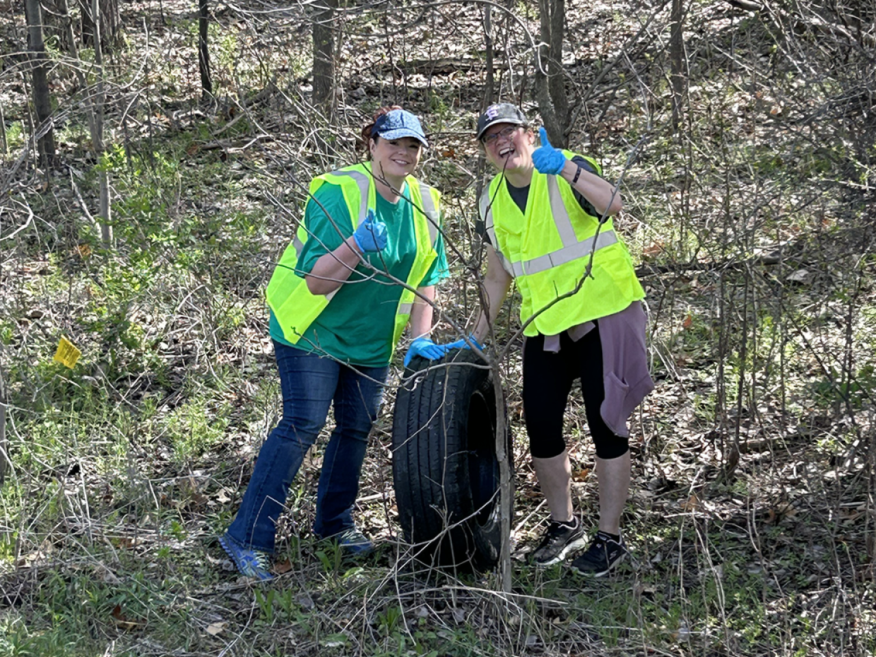 Two people in safety vests giving thumbs up