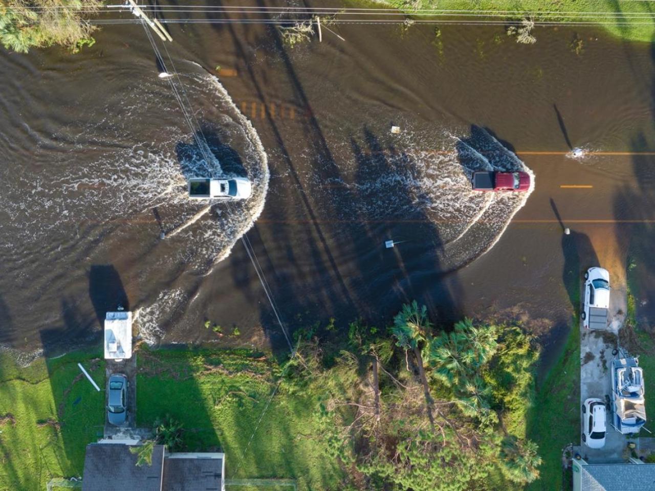 Aerial view of cars driving through a flooded street
