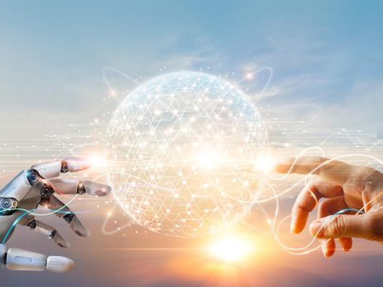 A robot and human hand reaching toward a digital sphere between them.