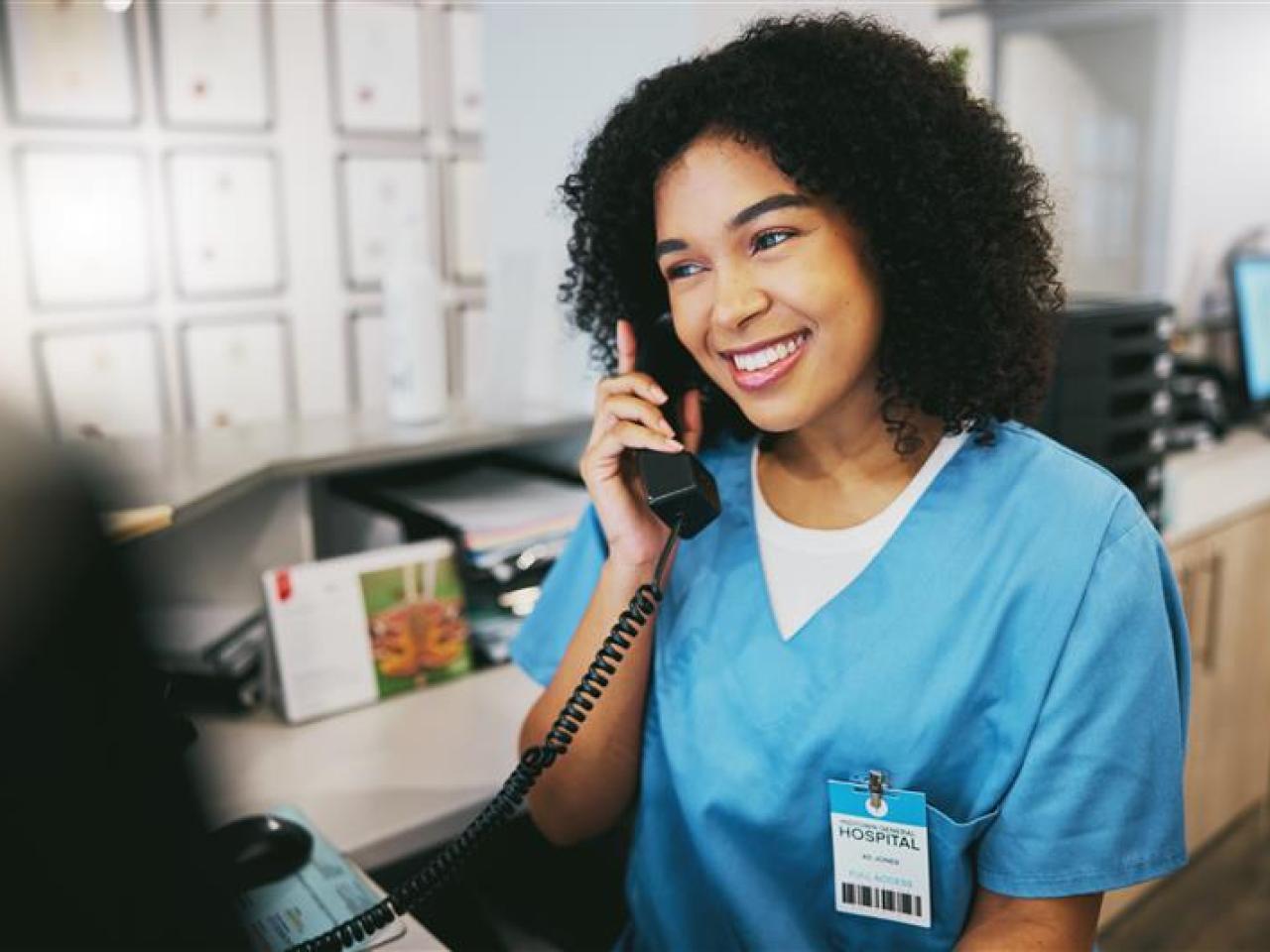A medical professional taking a phone call.
