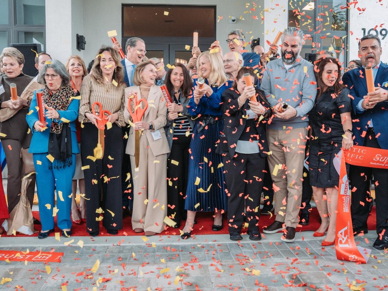 group photo behind ribbon