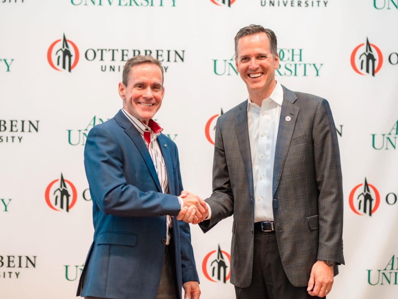William R. Groves, J.D., chancellor of Antioch University, and John Comerford, Ph.D., president of Otterbein University, shake hands after the historic announcement of their institutions' intention to affiliate with each other to create a unique, national, nonprofit university system focused on educating students both for careers and to prepare students to advance social justice, democracy, and the common good.