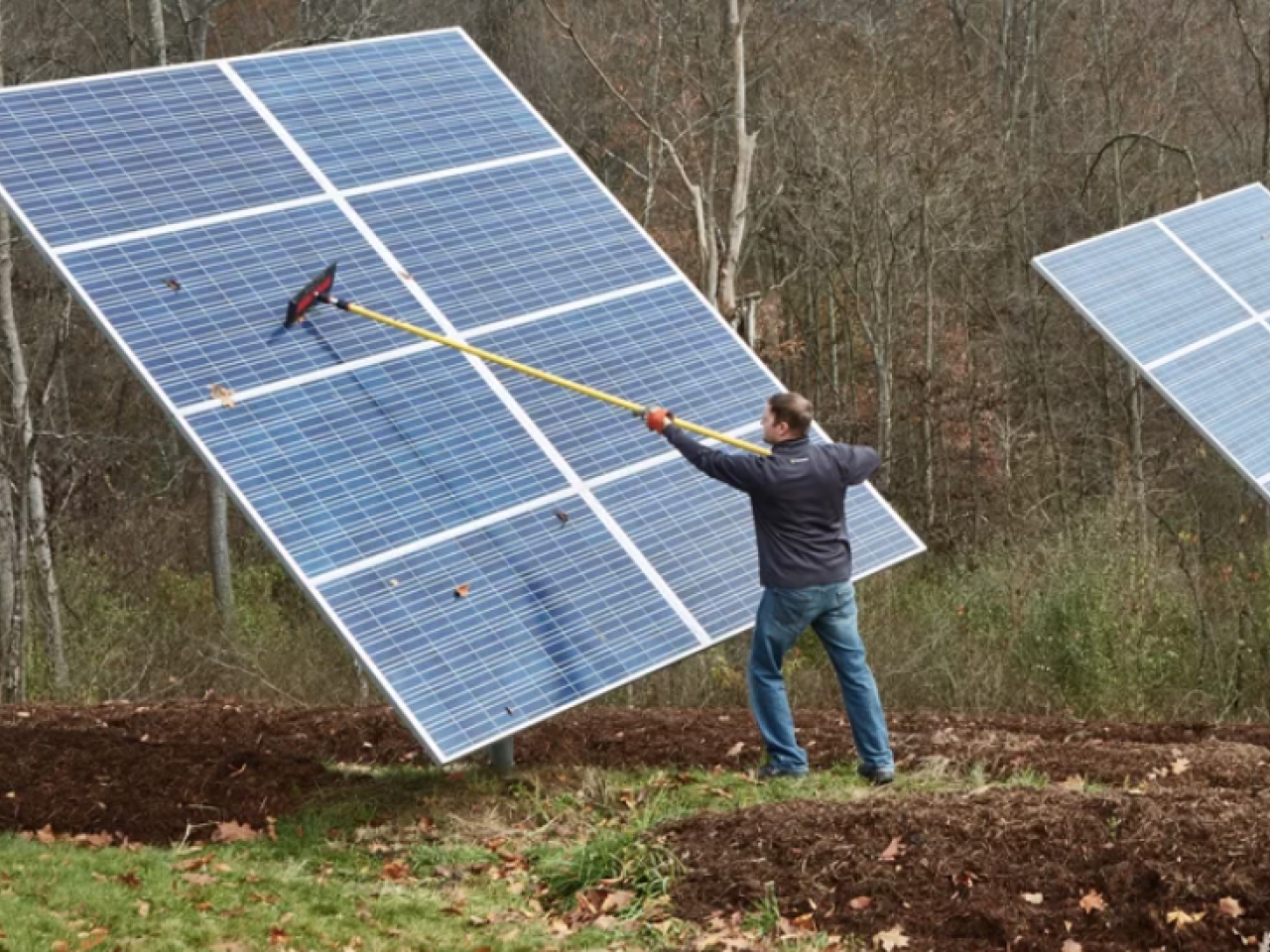 Chris Meyer cleans off the Solar panels at his home