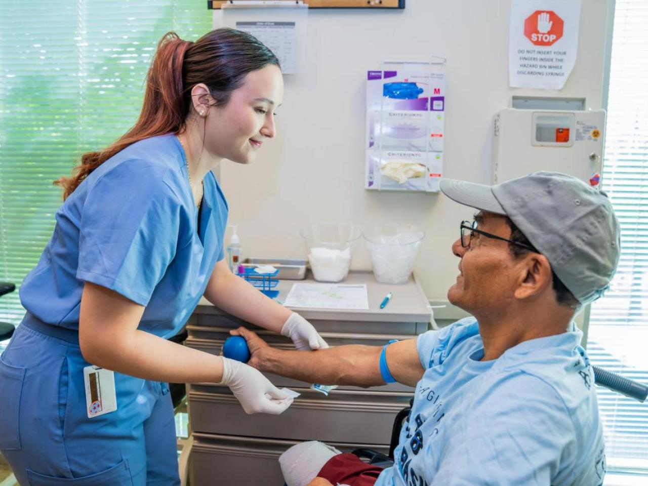 Lab Technician prepares to draw blood from a patient