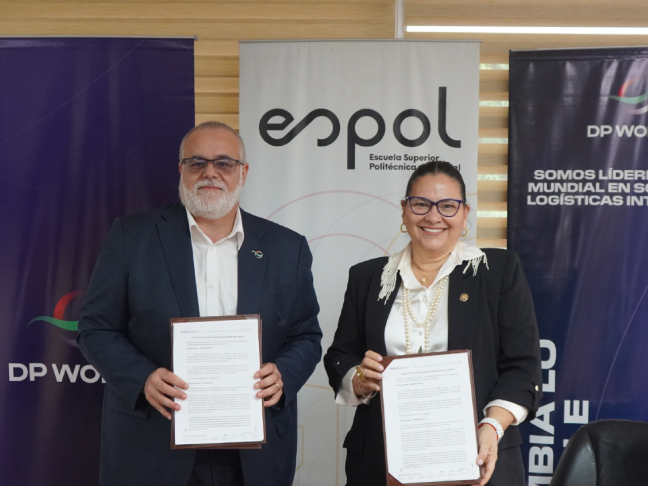 Representatives from DP World and ESPOL display the signed agreement establishing a partnership to monitor the ecological impact of Living Seawalls at the Port of Posorja.