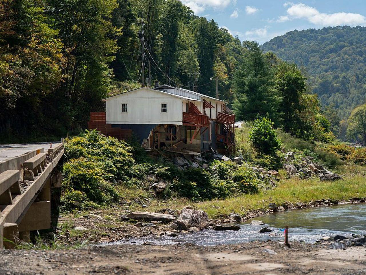 Photo of a house on a riverbank.