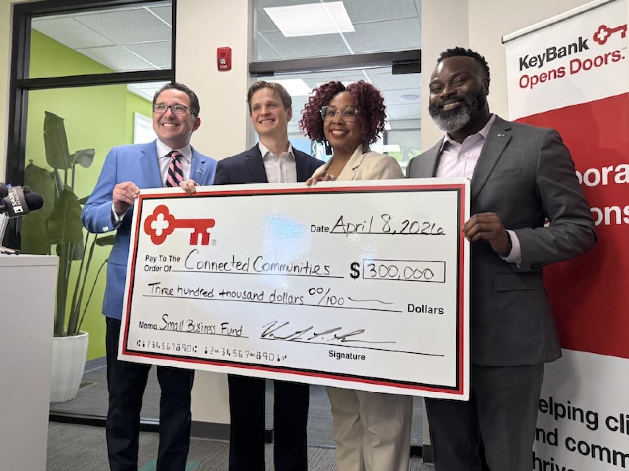 Team members from The KeyBank Foundation present a check for $300,000.
