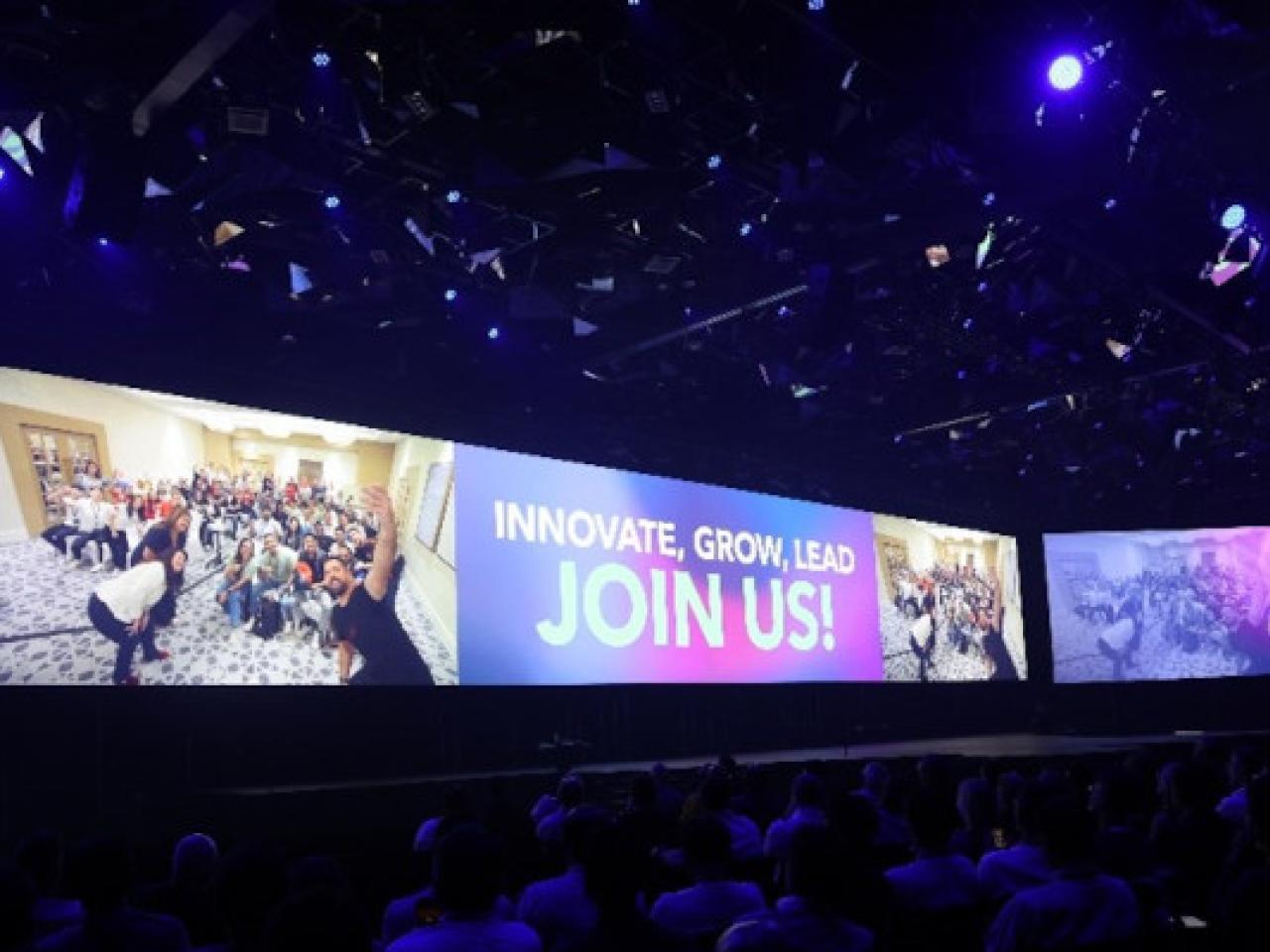 Screen behind the stage for GFC displaying the words, "Join Us!" 