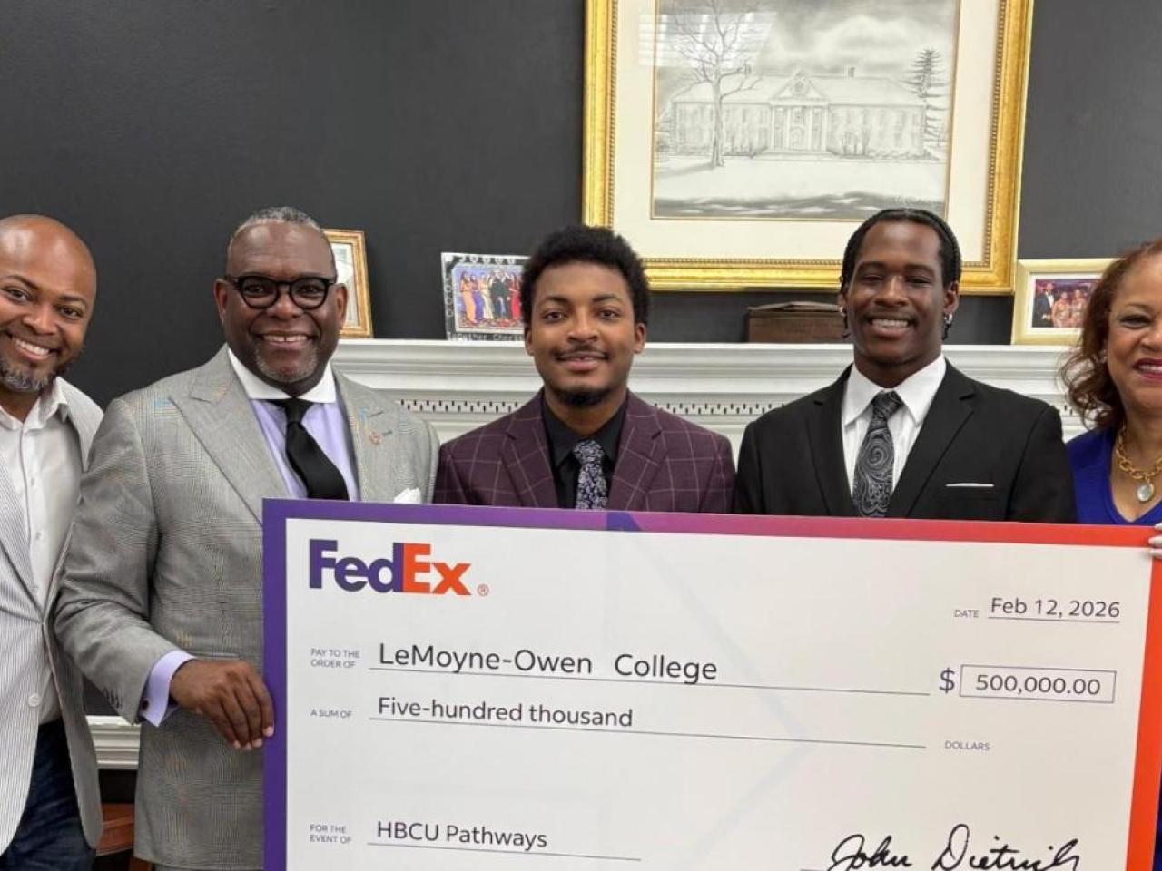 Group holding up a check from FedEx to LeMoyne‑Owen College