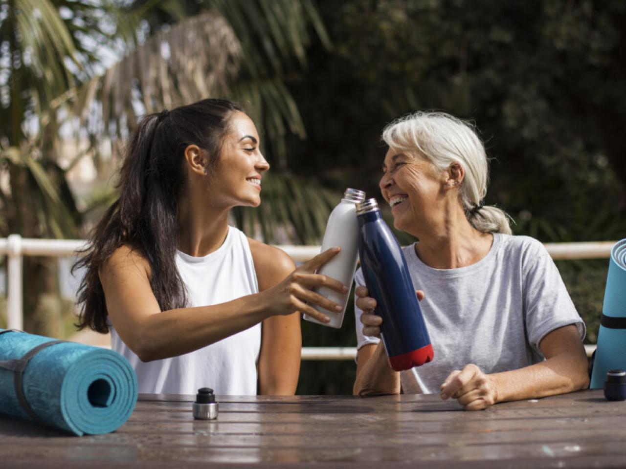 Two women drinking water after yoga.
