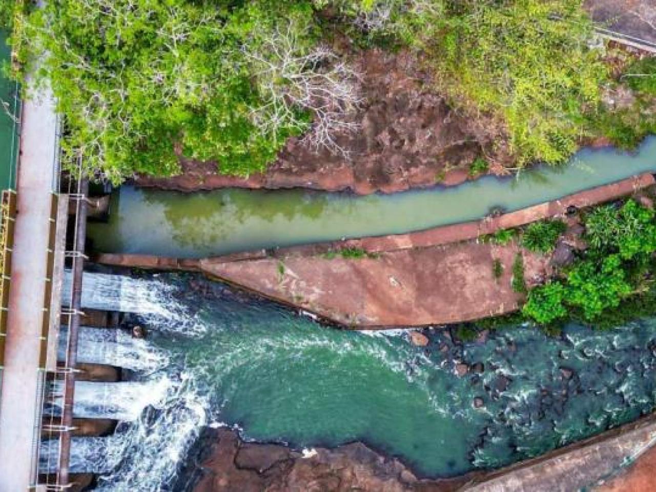 Aerial view of water running through a dam