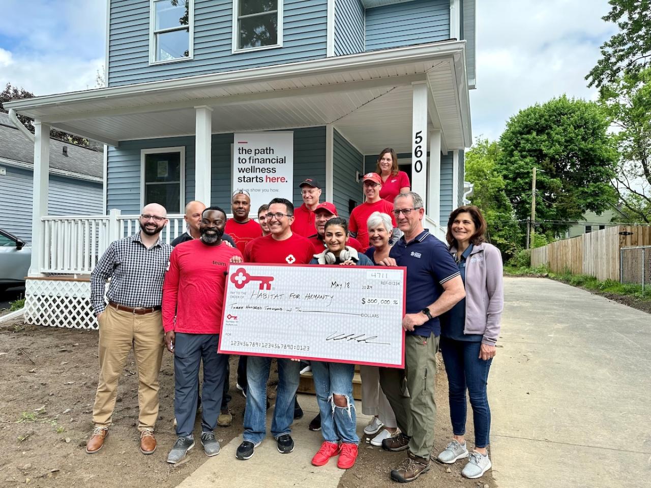 KeyBank and Rochester Habitat for Humanity team members shown with a $300,00 grant check.