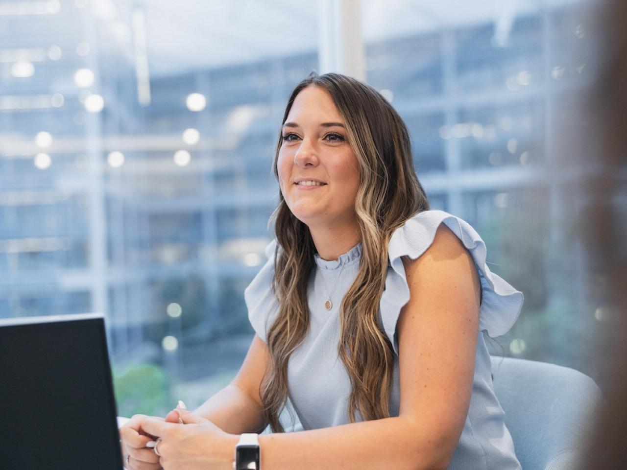 Principal employee seated in front of a laptop.