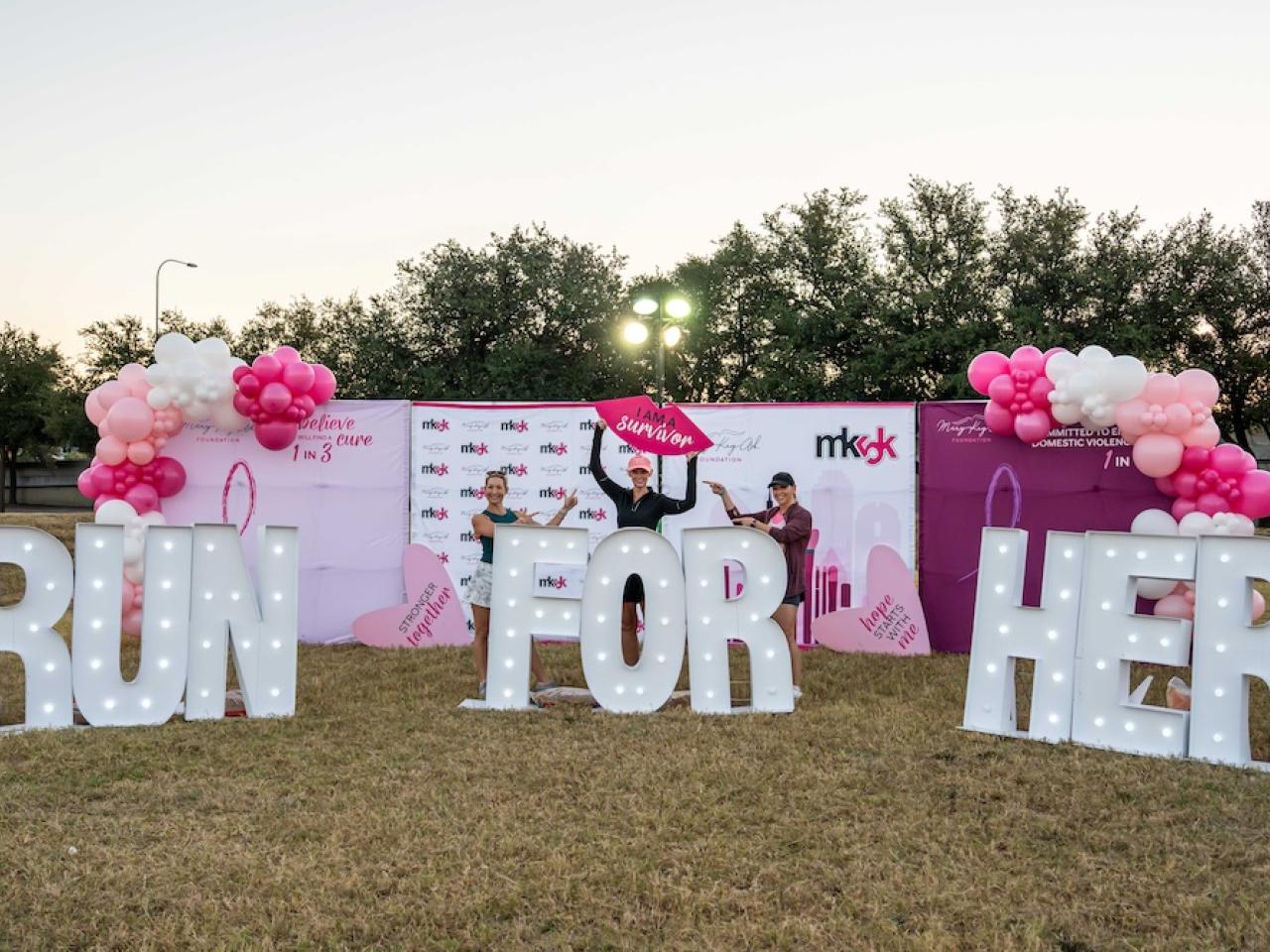 Sign reading "RUN FOR HER"