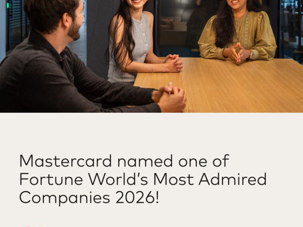 Three people sitting at table talking