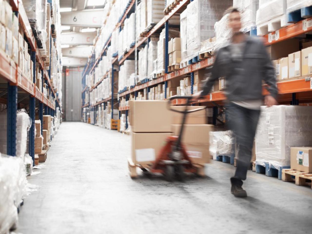 Worker pulling boxes in a warehouse