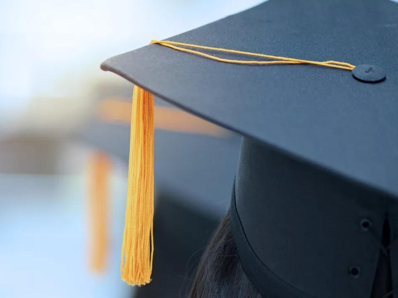 Graduates mitre shown with gold tassel.
